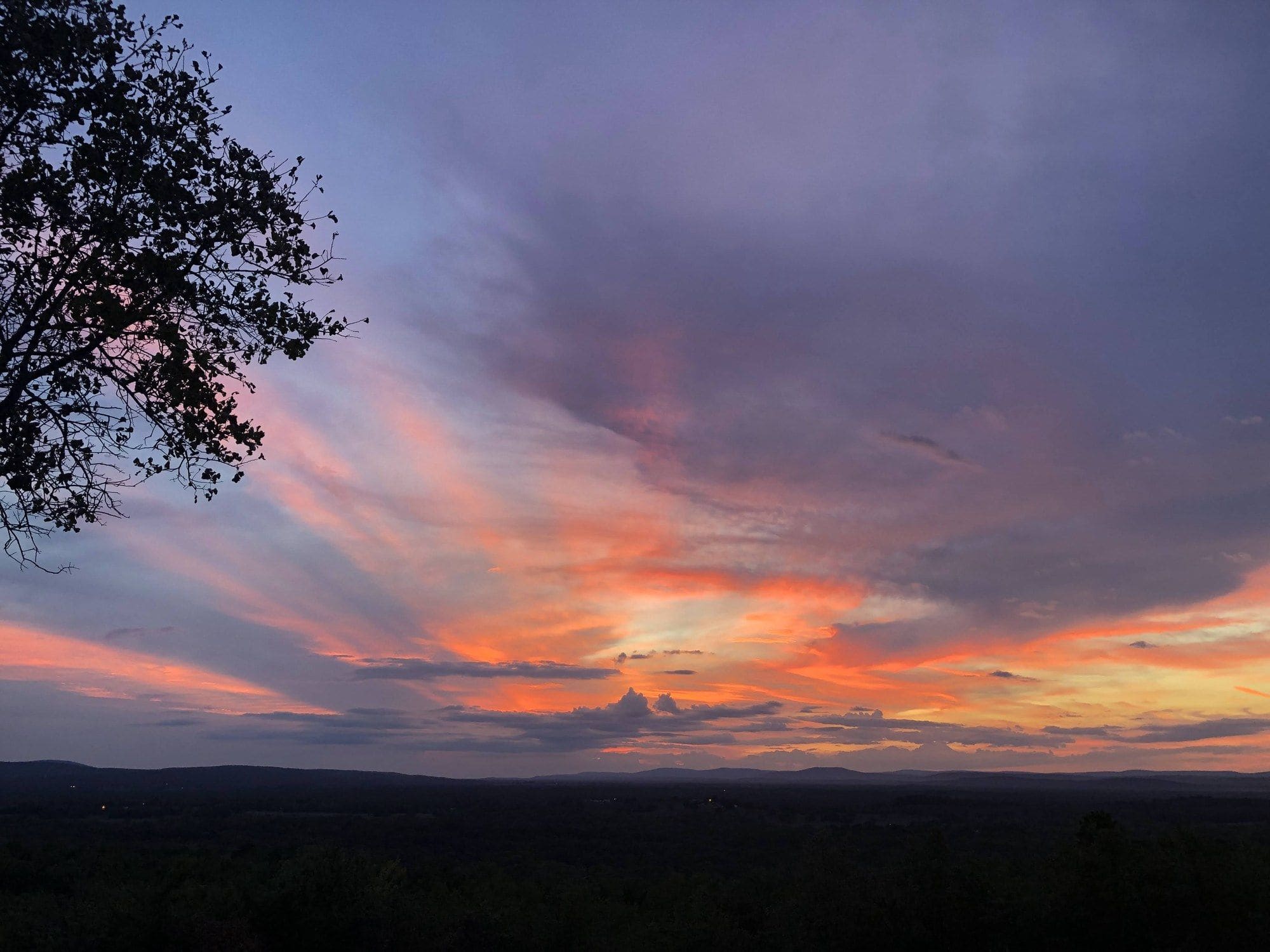 Pink and orange sunset over the mountains from the Panorama Ranch hilltop