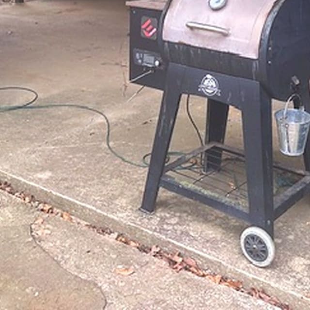 A Pit Boss grill under the carport
